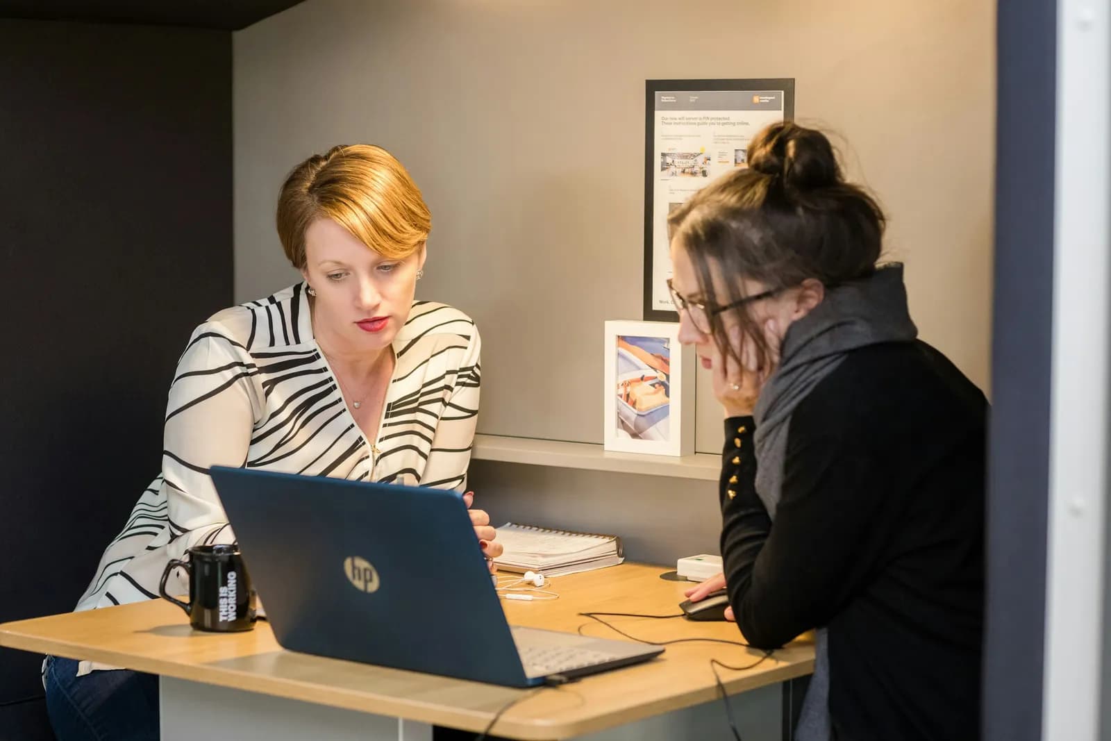 women looking at a laptop - Flight Price Tracker